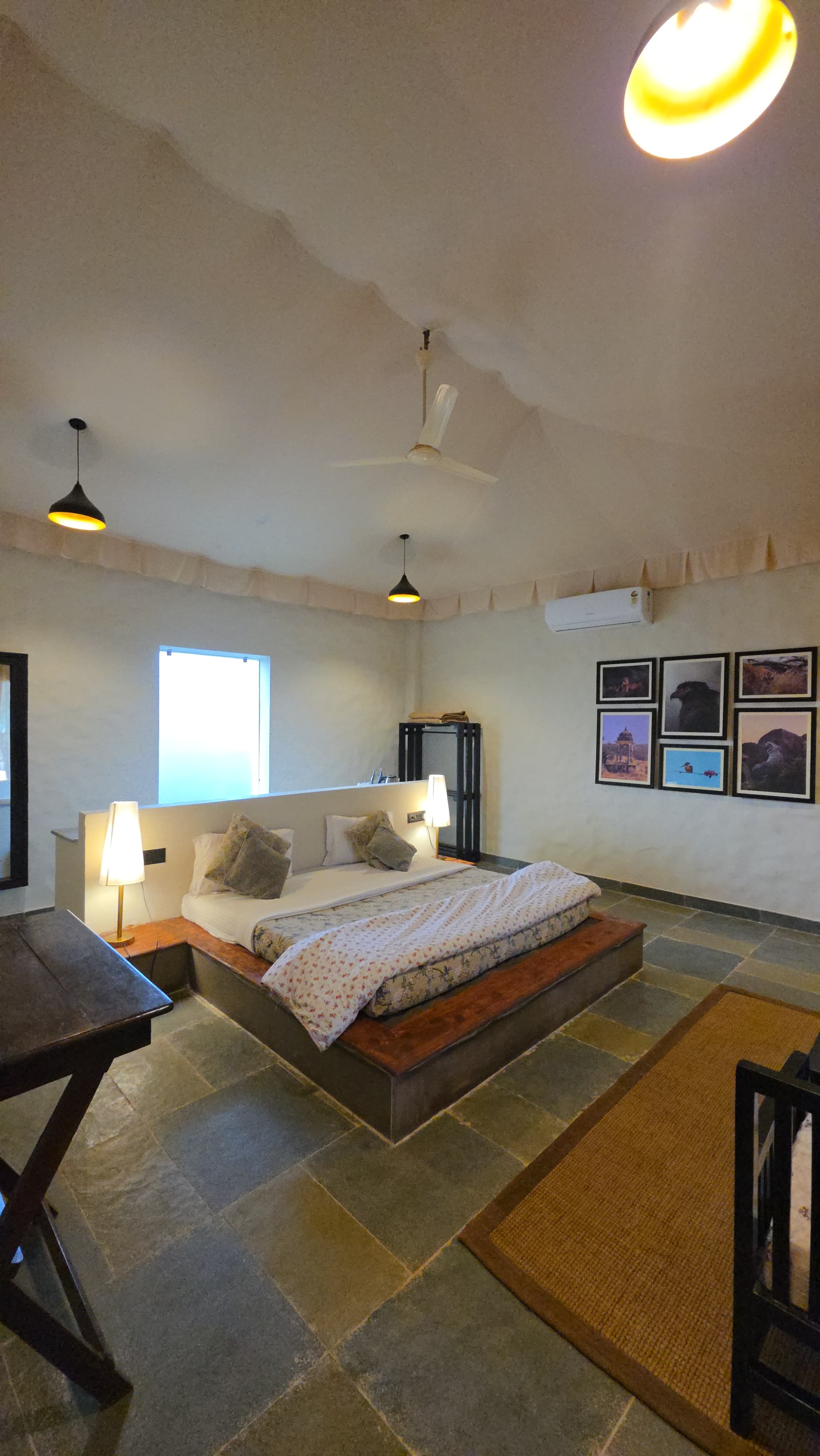 Lodge suite interior with earthy tones, lantern lighting, and wildlife prints on the wall